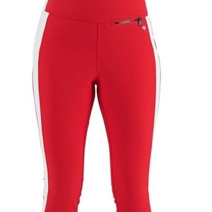 Red Obermeyer jinks in boots ski pants